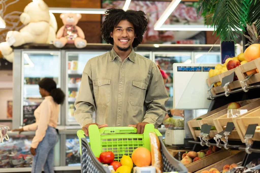 African American Man Shopping Grocery Products Posing In Store