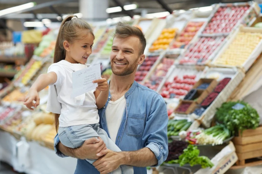 Happy Young Father in Supermarket