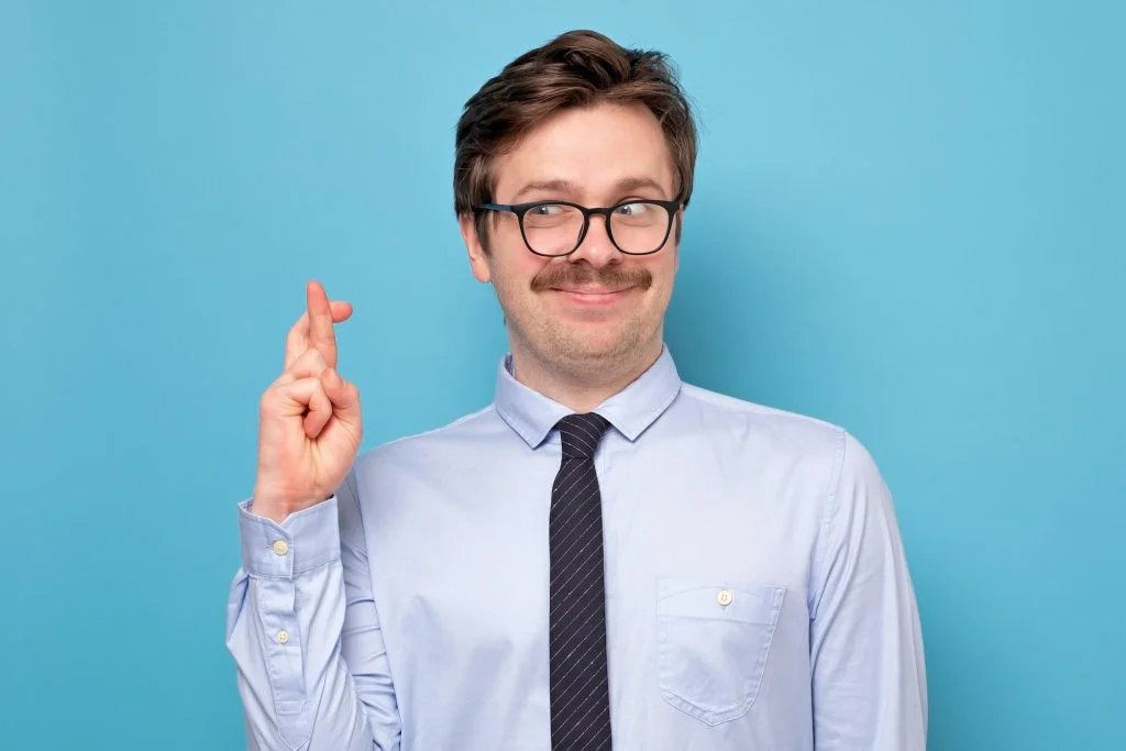 Businessman with crossed fingers is a true liar.