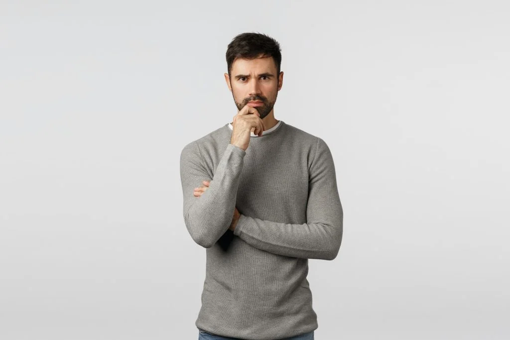 Concerned and serious young man trying understand how solve problem, finding resolve. Handsome