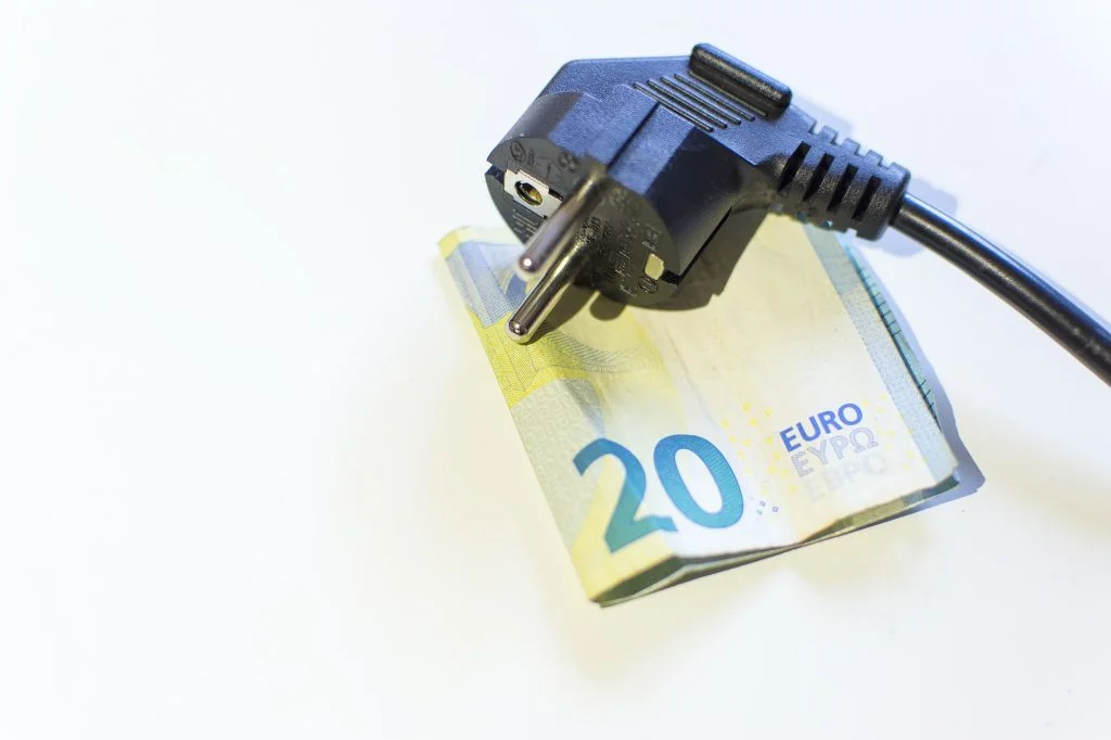 Power plug, energy-saving euro banknotes. Electricity high price.