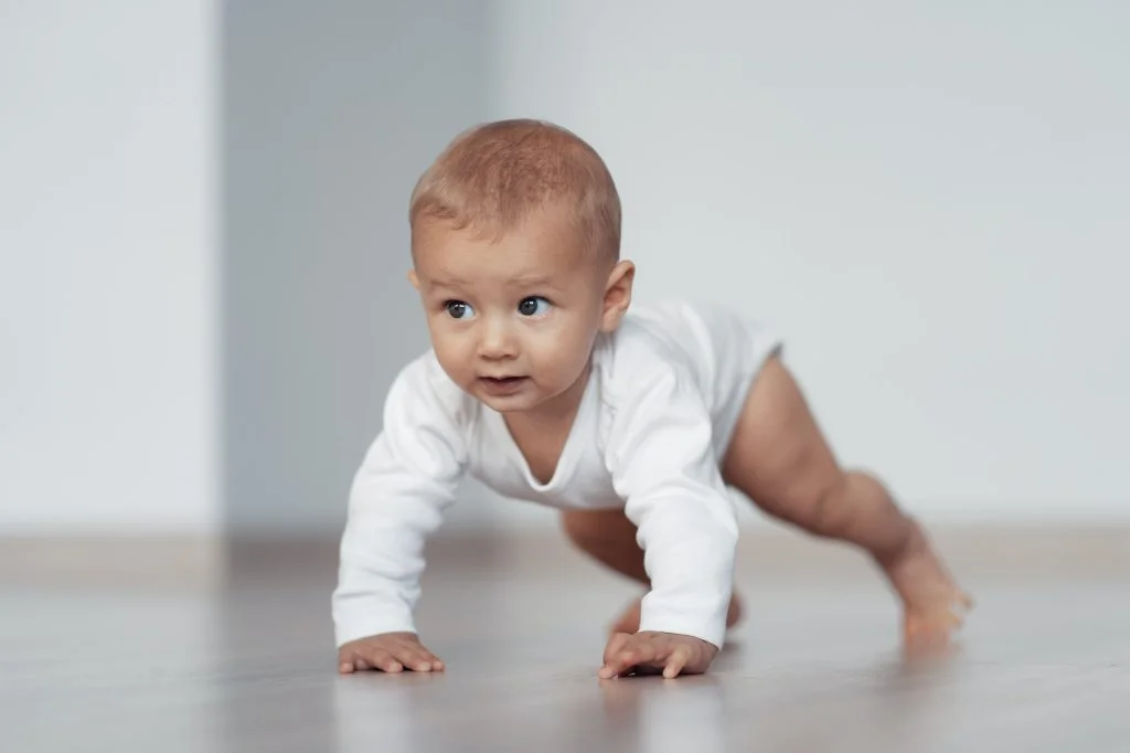 The kid is trying to take his first steps