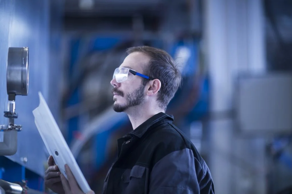Engineer checking pressure gauge