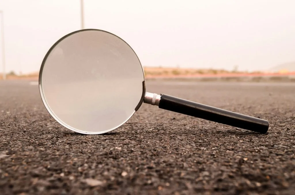 Magnifying Glass Loupe on the Asphalt Road